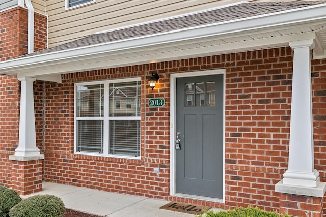 view of exterior entry featuring a porch