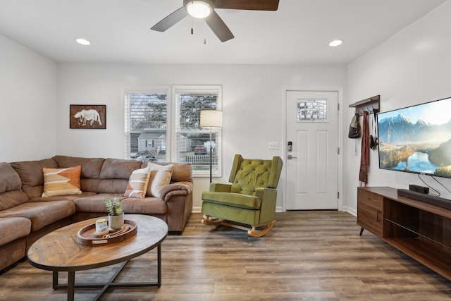 living room featuring hardwood / wood-style floors and ceiling fan