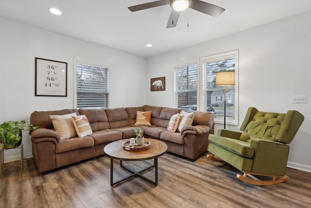 living room with ceiling fan, plenty of natural light, and dark hardwood / wood-style flooring