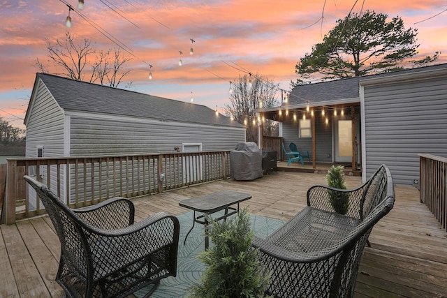 deck at dusk with grilling area