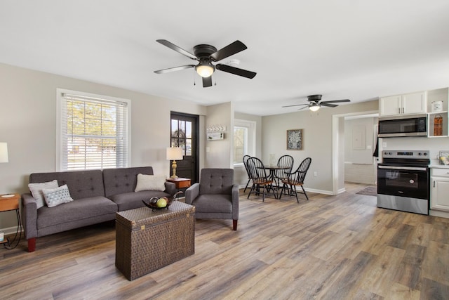 living room featuring ceiling fan and wood-type flooring