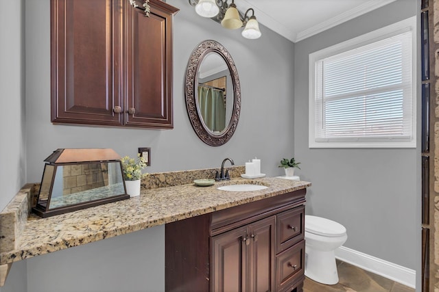 bathroom featuring vanity, ornamental molding, and toilet