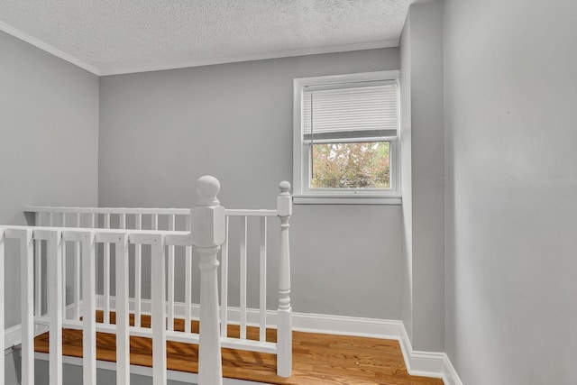 stairs featuring hardwood / wood-style flooring and a textured ceiling