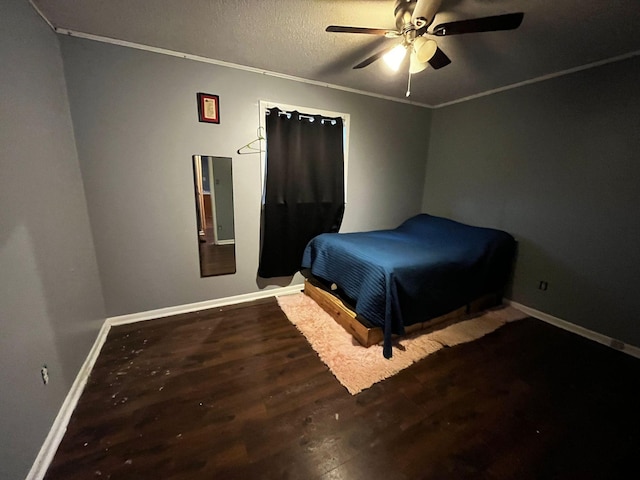 bedroom featuring ceiling fan, crown molding, wood-type flooring, and a textured ceiling