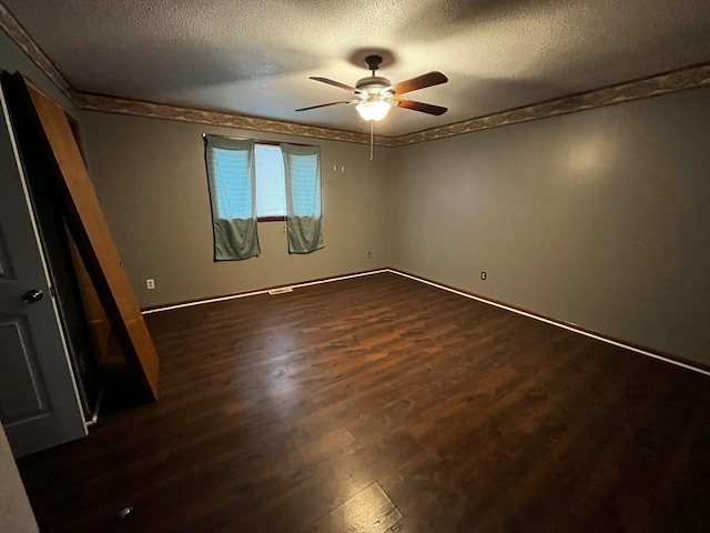 unfurnished bedroom with ceiling fan, a textured ceiling, and dark hardwood / wood-style flooring