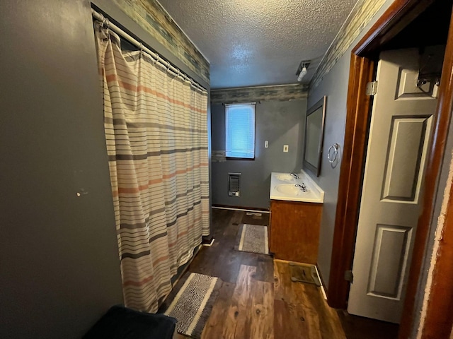 bathroom with vanity, hardwood / wood-style floors, and a textured ceiling