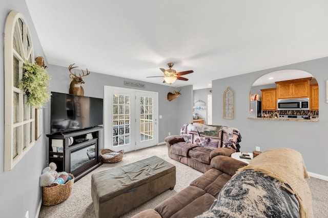 carpeted living room with ceiling fan