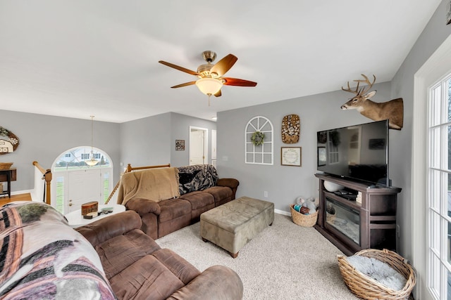 carpeted living room with ceiling fan and a wealth of natural light