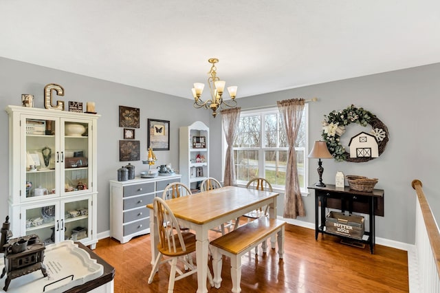 dining room featuring light hardwood / wood-style flooring and a chandelier