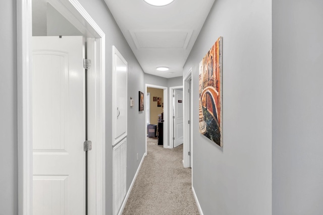 hallway with light colored carpet