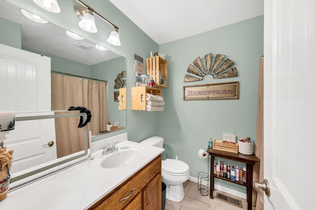 bathroom with vanity, toilet, and tile patterned floors