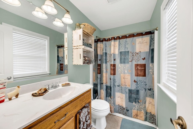 bathroom with plenty of natural light, vanity, toilet, and tile patterned floors