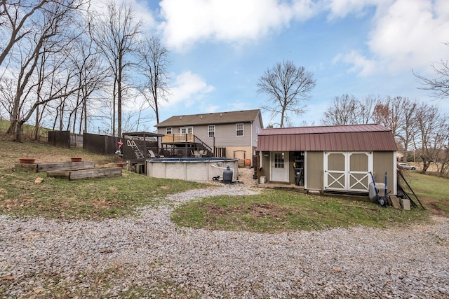 rear view of house with a storage shed