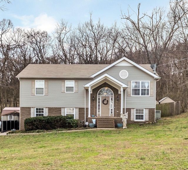 split foyer home with a front lawn