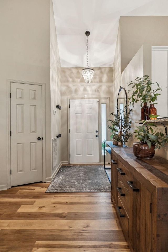 foyer featuring a notable chandelier and light hardwood / wood-style floors