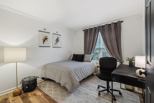 bedroom featuring ornamental molding and hardwood / wood-style flooring