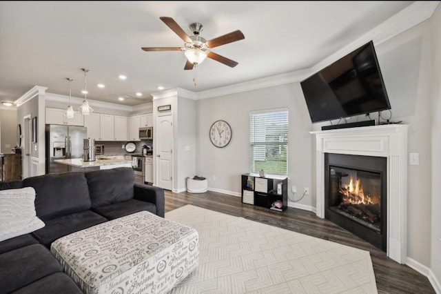 living room featuring crown molding, ceiling fan, and hardwood / wood-style flooring