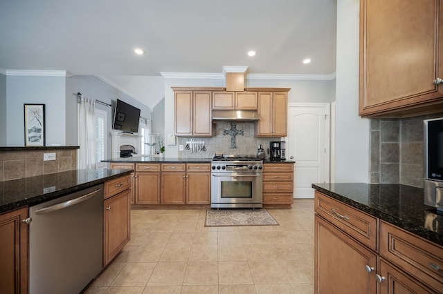 kitchen with light tile patterned flooring, stainless steel appliances, crown molding, and dark stone countertops