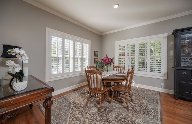 dining room with ornamental molding and wood-type flooring