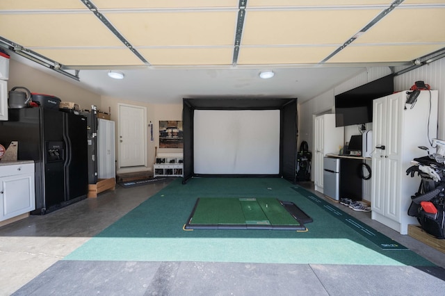 garage with black fridge