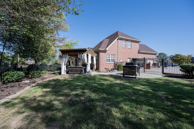 rear view of house featuring a patio, a yard, and a jacuzzi