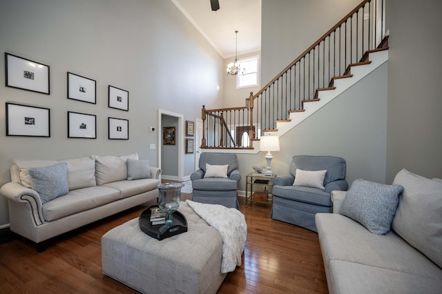 living room featuring a high ceiling, an inviting chandelier, and dark hardwood / wood-style flooring