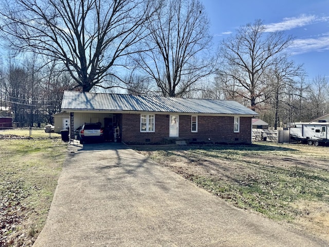 ranch-style house with metal roof, an attached carport, brick siding, concrete driveway, and crawl space