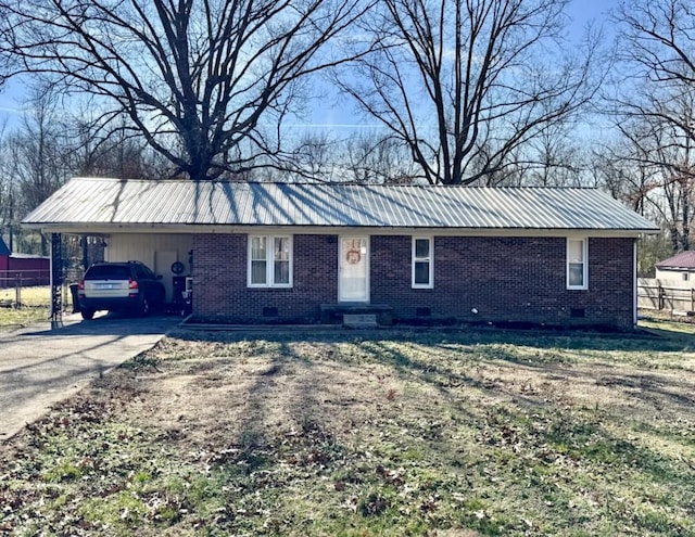 ranch-style home featuring metal roof, a carport, brick siding, and crawl space