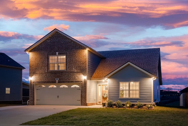 view of front property featuring a garage and a lawn