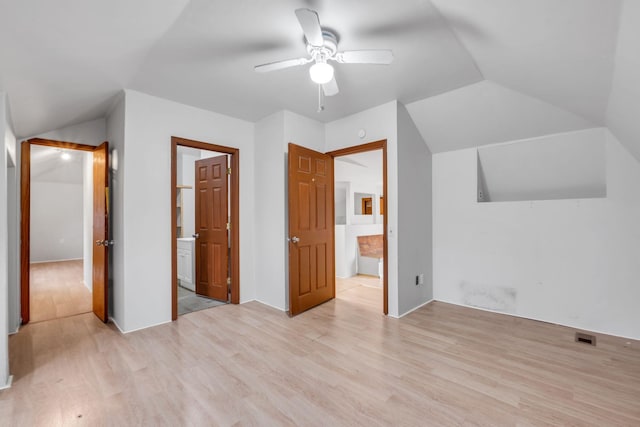 unfurnished bedroom with lofted ceiling, light hardwood / wood-style flooring, and ceiling fan