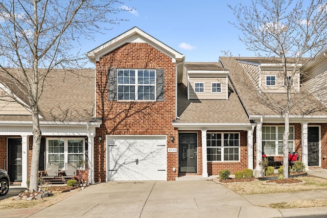 view of front of property featuring driveway, an attached garage, roof with shingles, and brick siding