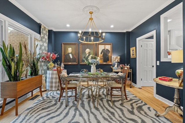 dining room with crown molding, wood-type flooring, and an inviting chandelier