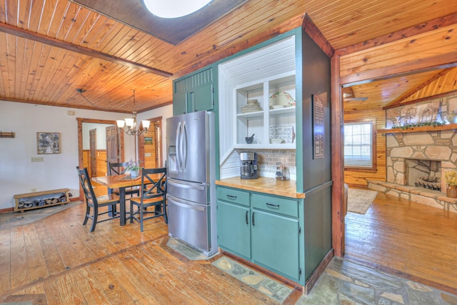 kitchen with wood ceiling, hardwood / wood-style flooring, an inviting chandelier, stainless steel refrigerator with ice dispenser, and decorative light fixtures