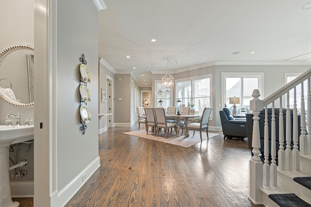 dining space featuring dark hardwood / wood-style flooring, ornamental molding, and a chandelier