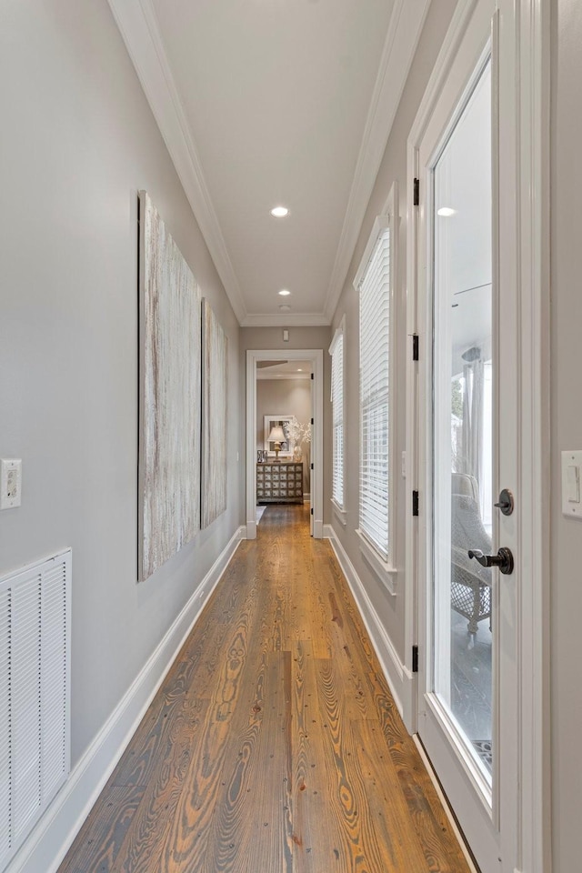 hallway featuring hardwood / wood-style floors and ornamental molding