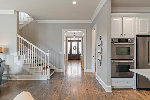 entryway with crown molding and wood-type flooring