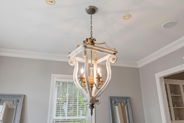 room details featuring ornamental molding and a chandelier