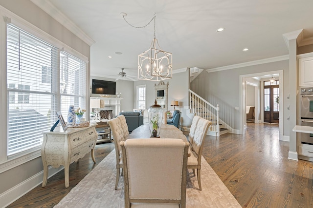 dining space featuring hardwood / wood-style floors, crown molding, and ceiling fan with notable chandelier