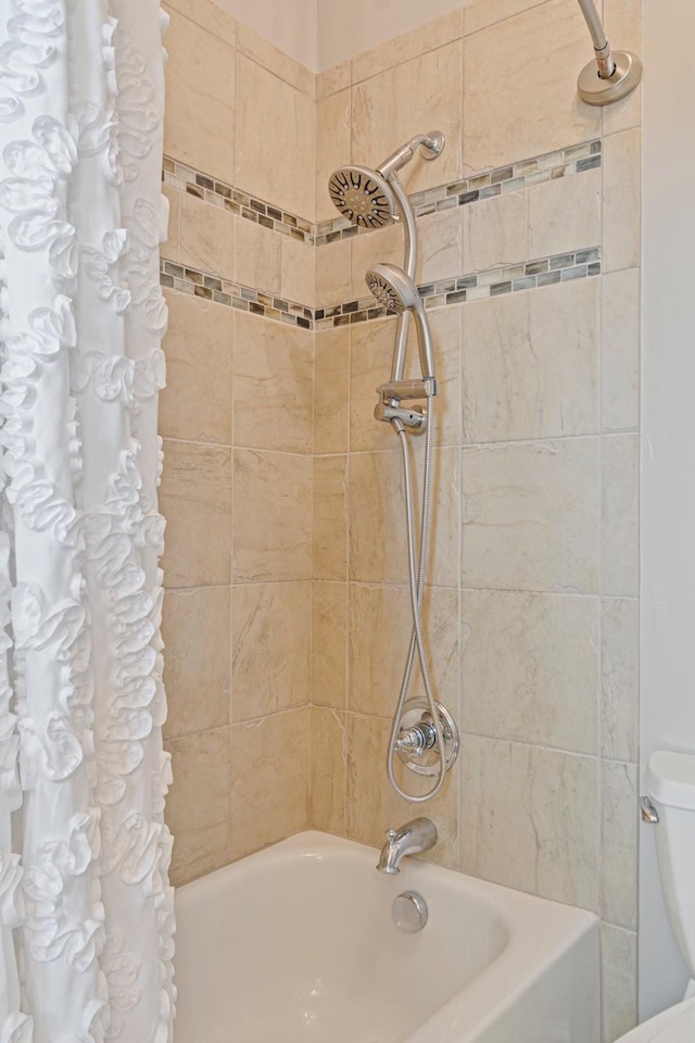 bathroom with shower / bathtub combination with curtain and toilet