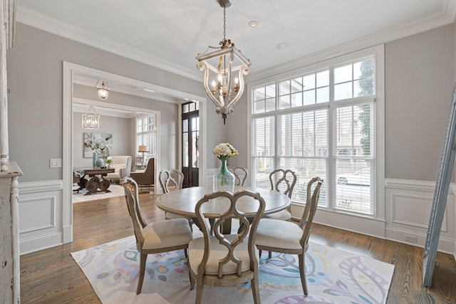 dining area with crown molding, dark hardwood / wood-style flooring, and a chandelier