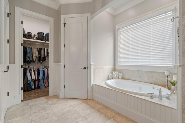 bathroom with ornamental molding, a washtub, and tile patterned floors