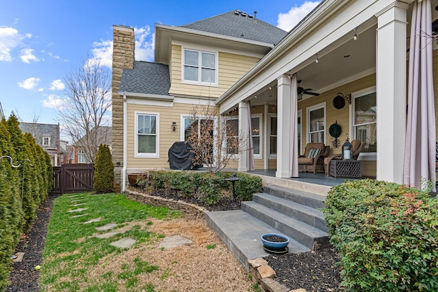 exterior space with ceiling fan and an outdoor living space