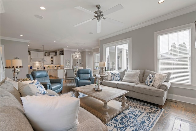 living room featuring crown molding, wood-type flooring, and ceiling fan