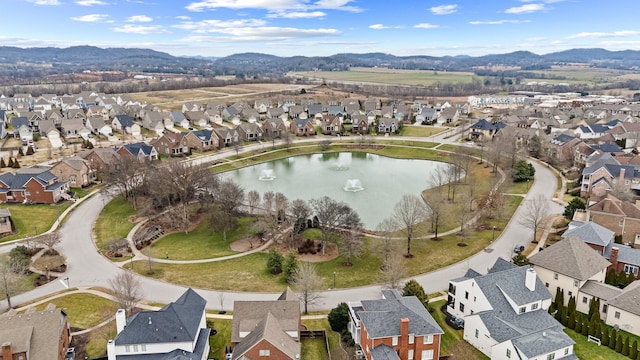 drone / aerial view featuring a water and mountain view