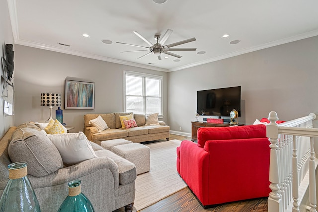 living room featuring dark hardwood / wood-style flooring, ornamental molding, and ceiling fan