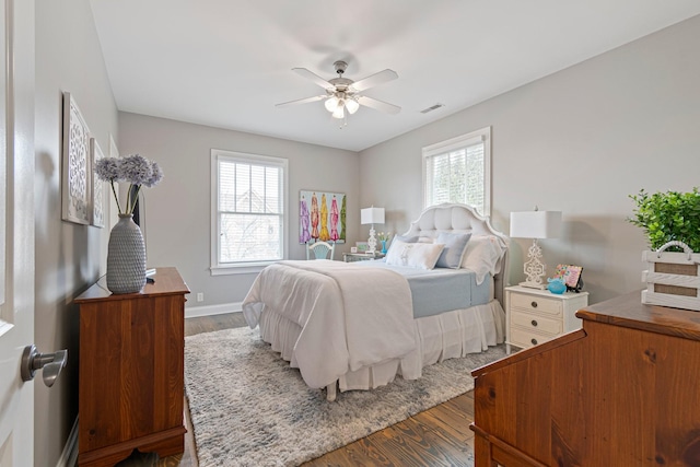 bedroom with dark hardwood / wood-style floors and ceiling fan