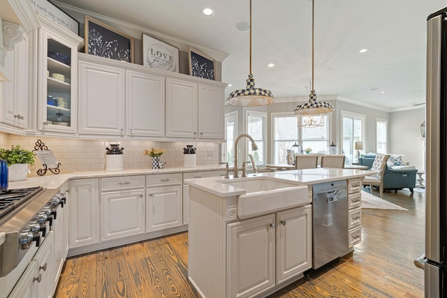 kitchen featuring sink, white cabinetry, decorative light fixtures, ornamental molding, and dishwasher