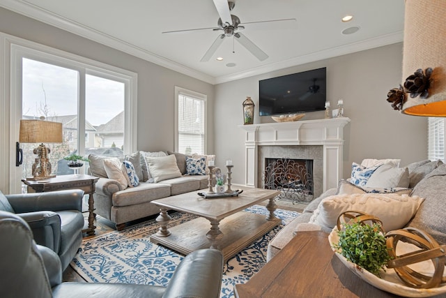 living room with crown molding, ceiling fan, and wood-type flooring