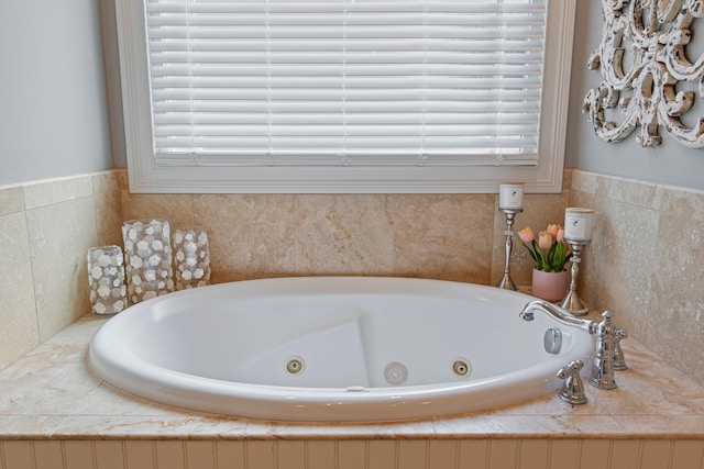 bathroom with tiled bath and a wealth of natural light