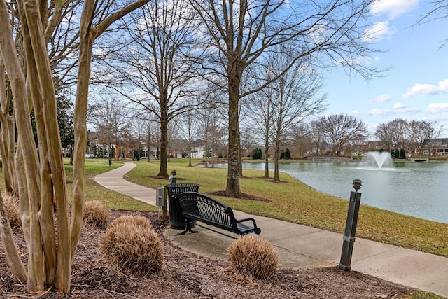 view of community featuring a yard and a water view